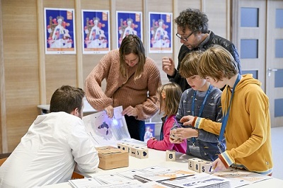 Adults and children collecting items for trail