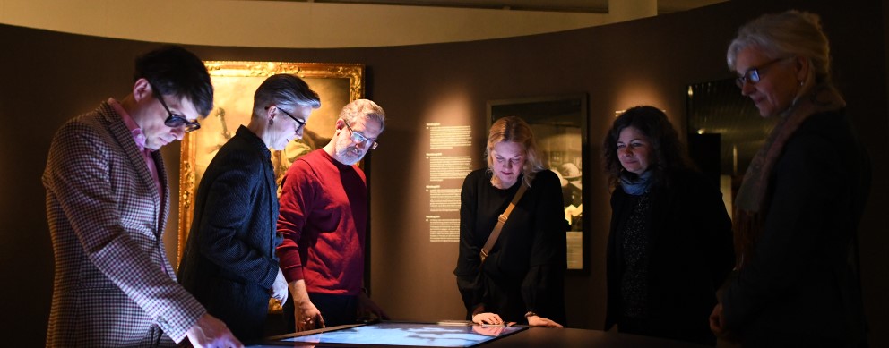 Les visiteurs de l'exposition Bellum et Artes utilisent un écran interactif