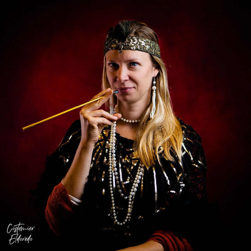 Woman dressed up in 1920s clothes smoking