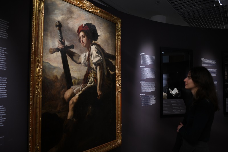 Woman in exhibition looking at painting