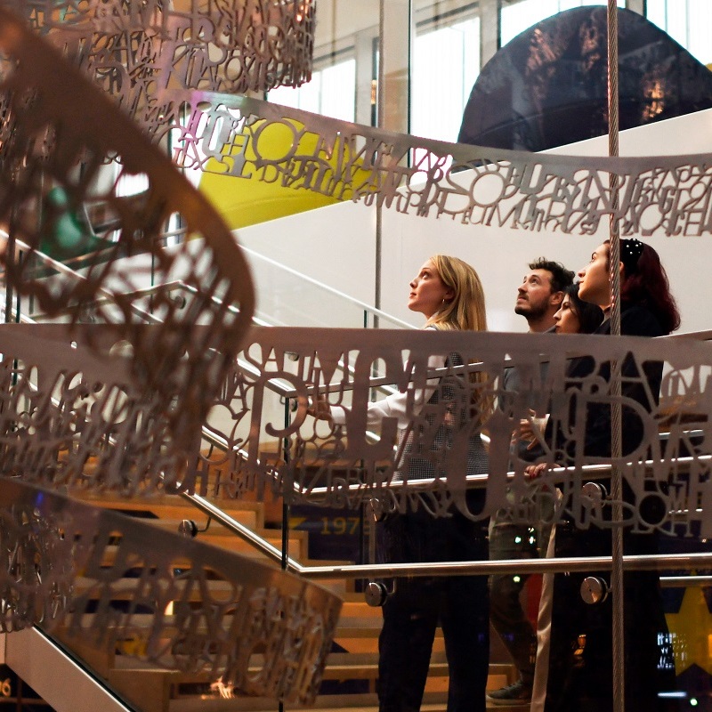 visitors looking at vortex sculpture