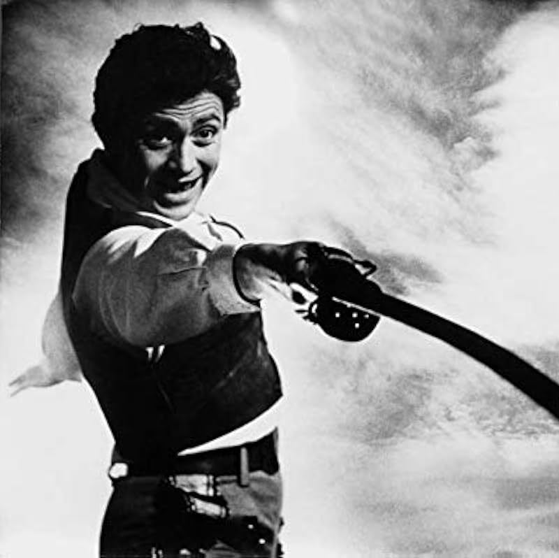 Black and white still of man with sword