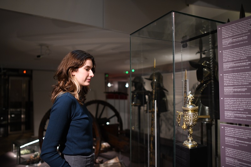 Woman looking at chalice from thirty years war