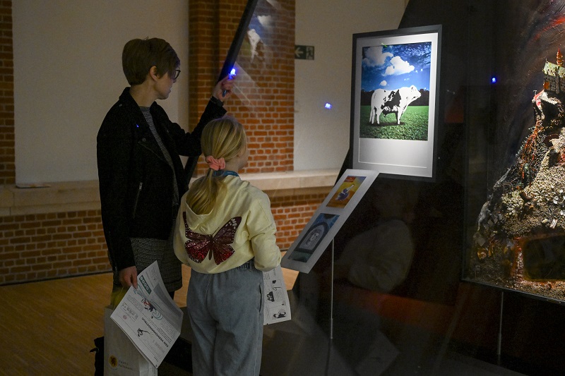 Parent and child looking at painting