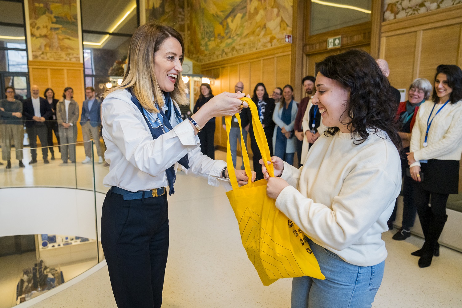 President Metsola handing over bag to visitor