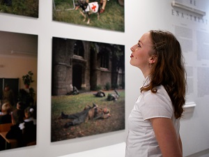 Woman looking at photos in exhibition