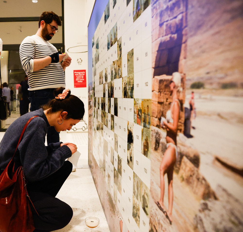 Woman adding photo to wall