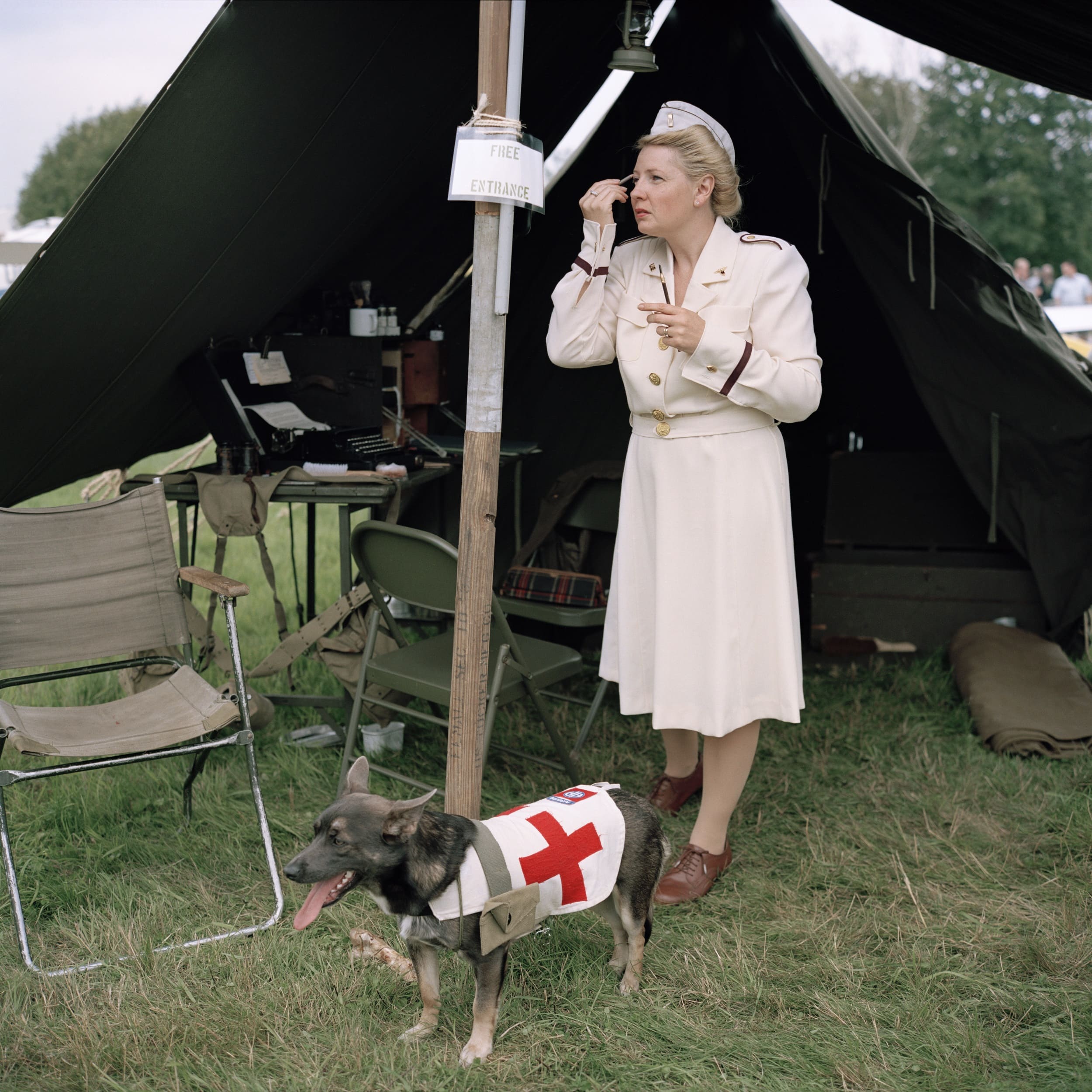 Woman doing makeup dressed as WW2 nurse
