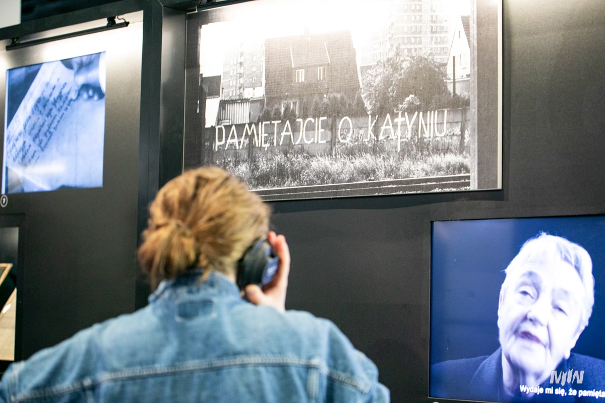 Woman listening to audio device in museum