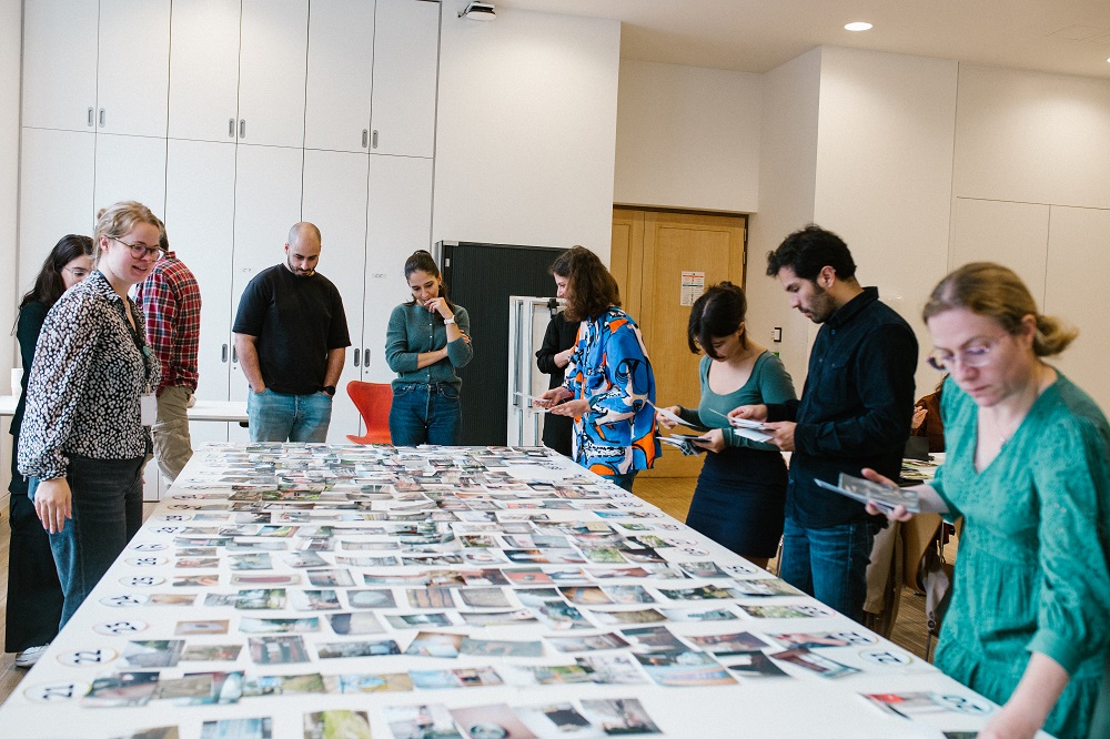 People looking at photos on desk