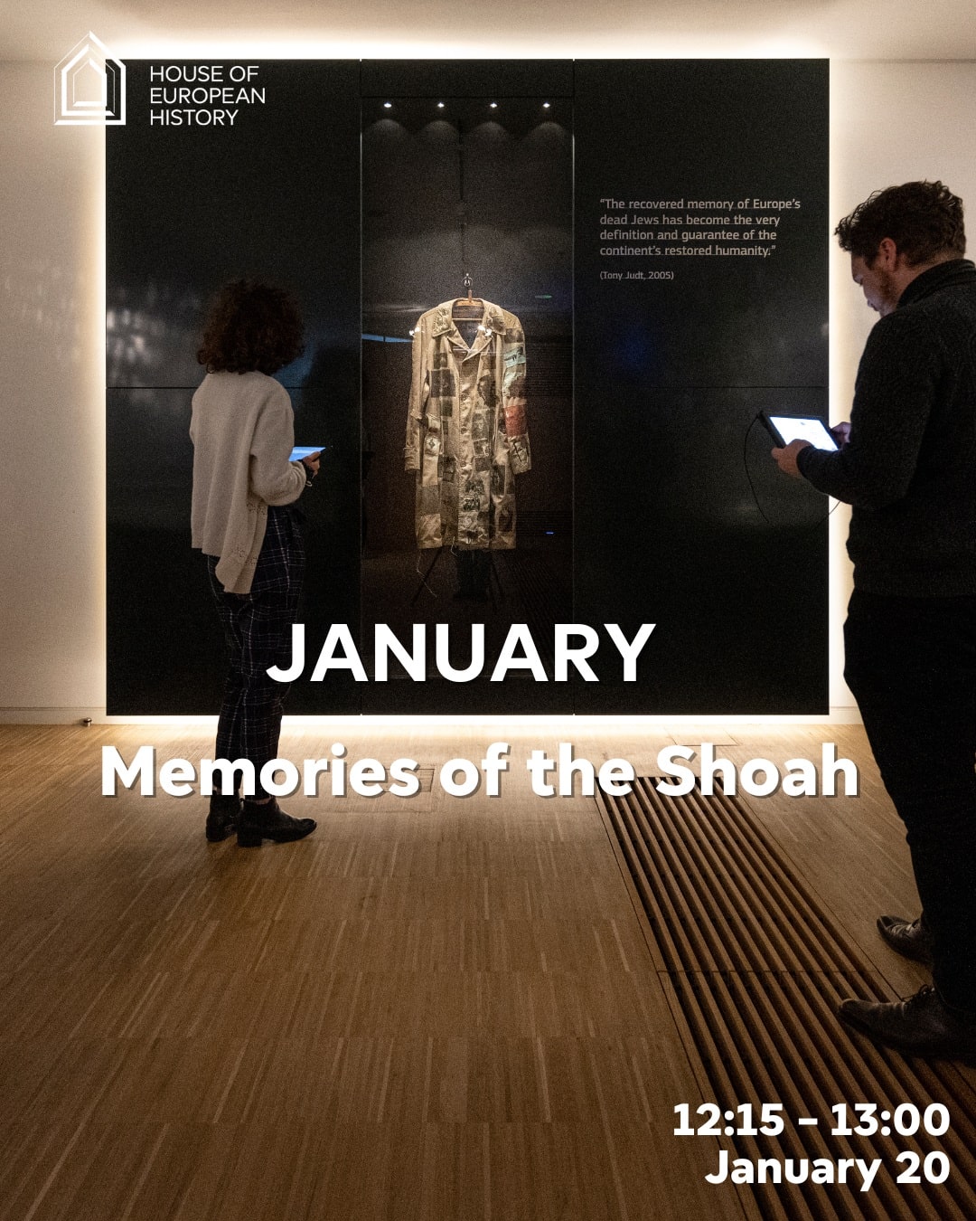 Two museum visitors looking at embroided coat