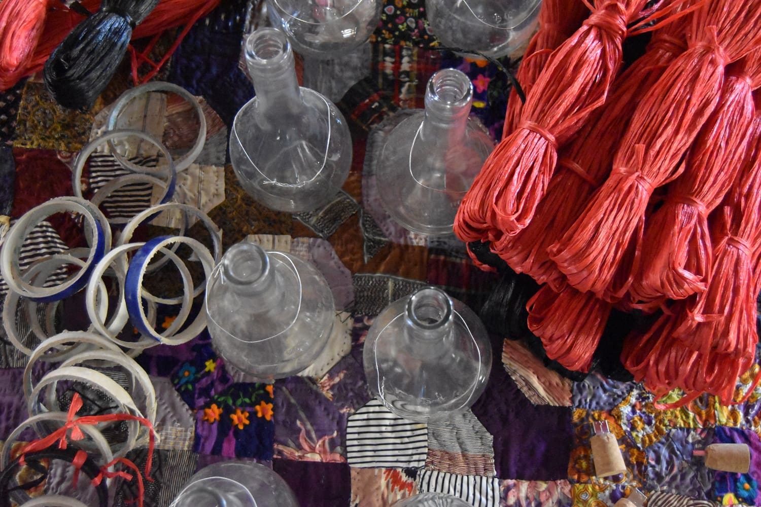 Bottles and fabrics on market stall