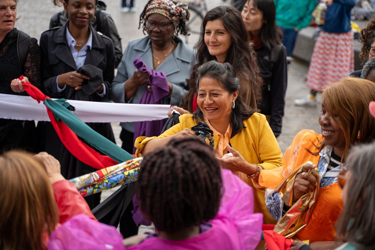 Woman in colourful jacket meeting people