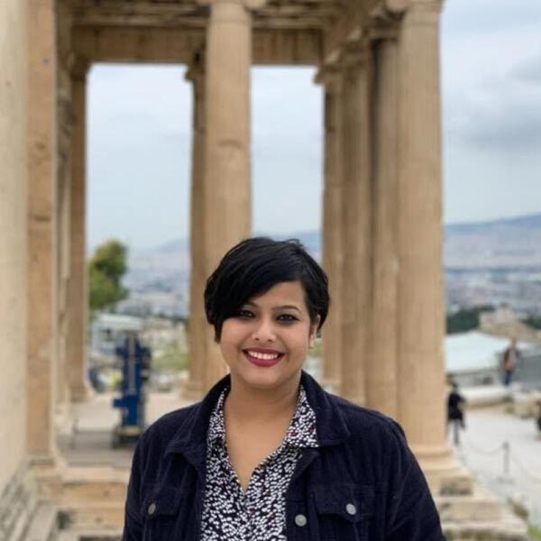Woman in front of ancient ruins
