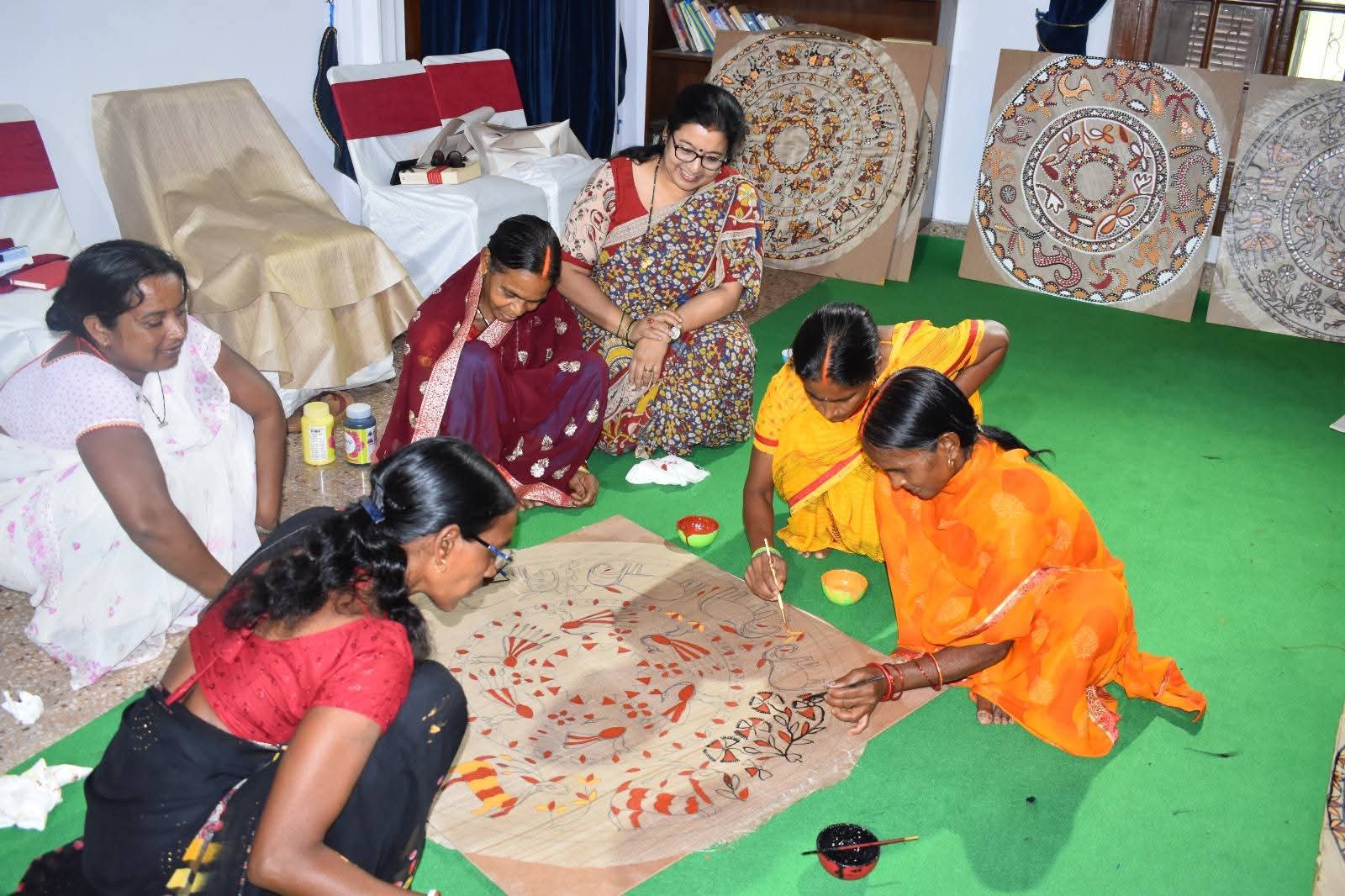 Indian women painting on floor