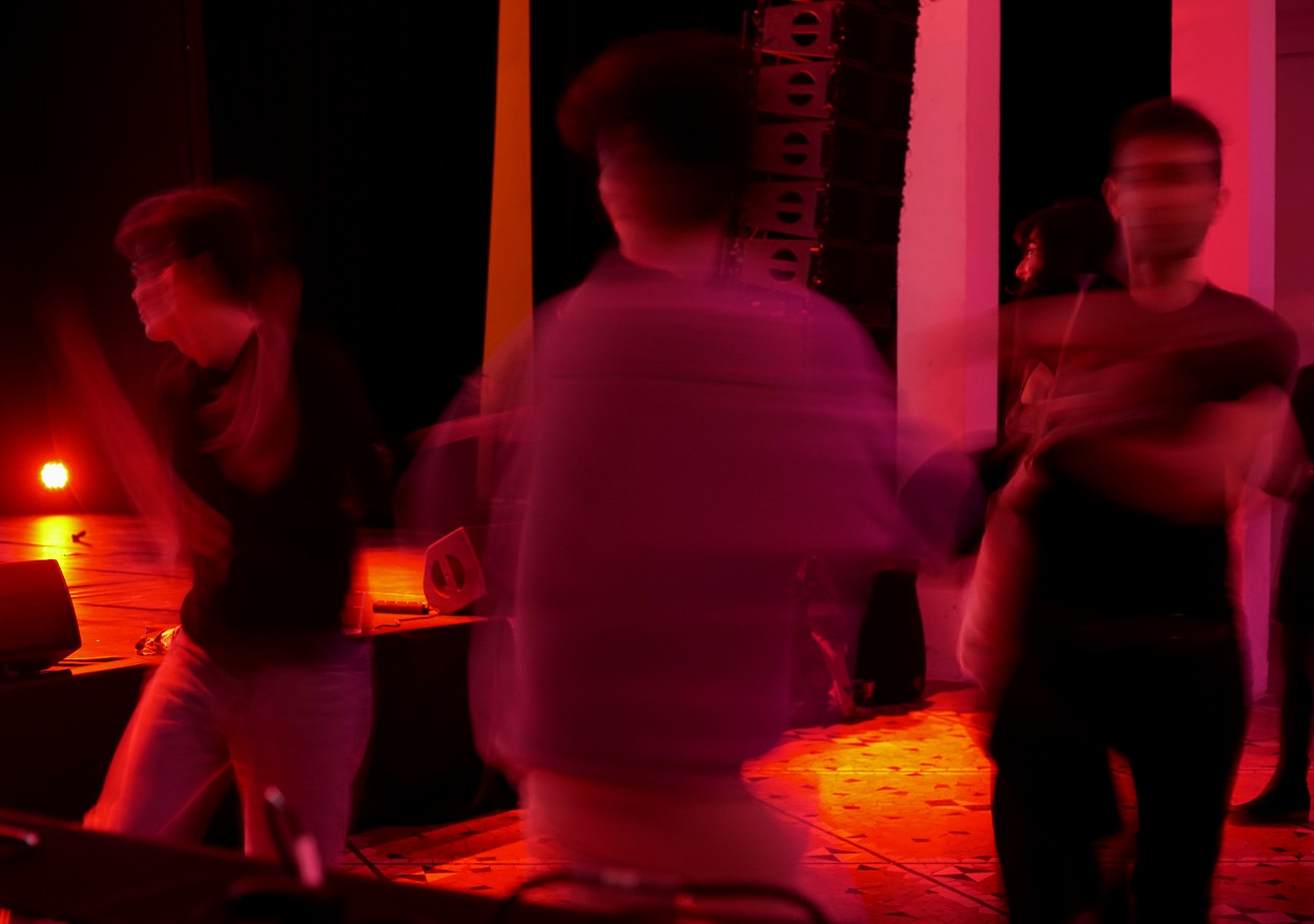 DJ and dancers in red
