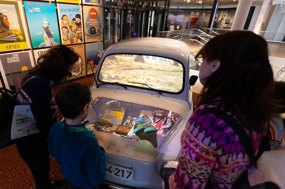 Family in front of car in museum