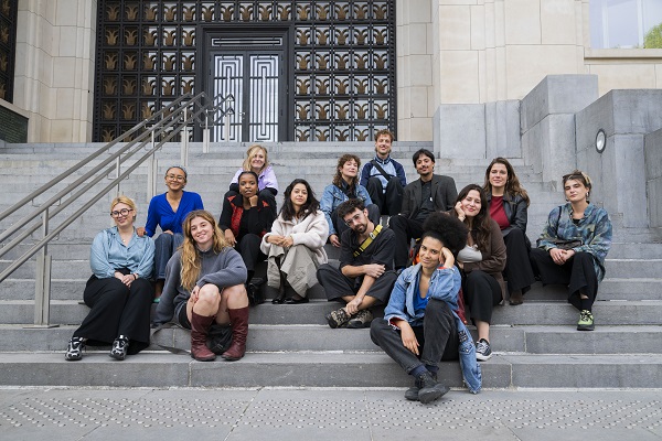 Group sitting on steps outside museum