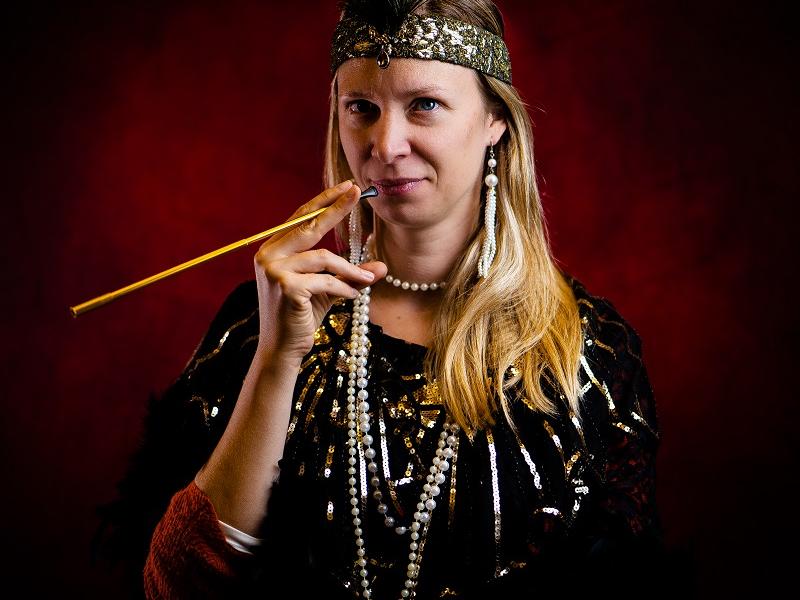 Woman dressed up in 1920s clothes smoking