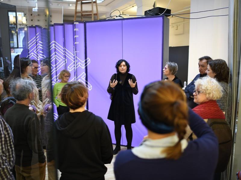 Curator giving tour in exhibition