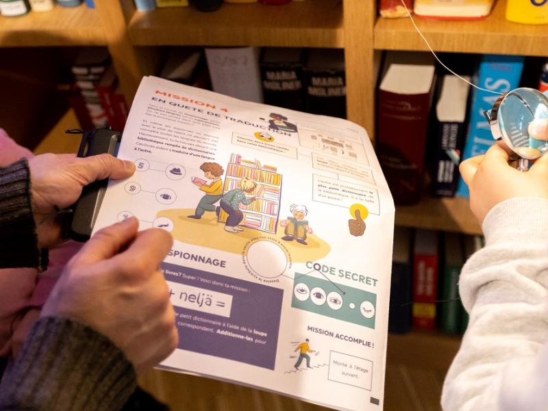 Museum newspaper in front of bookcase
