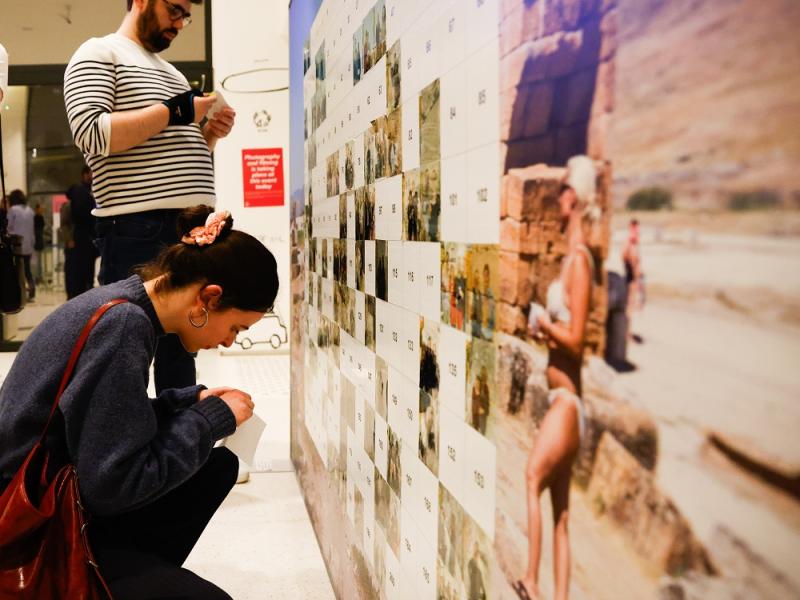 Woman adding photo to wall