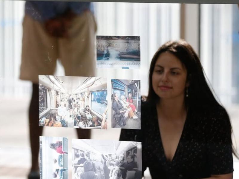 Woman looking at photos in exhibition