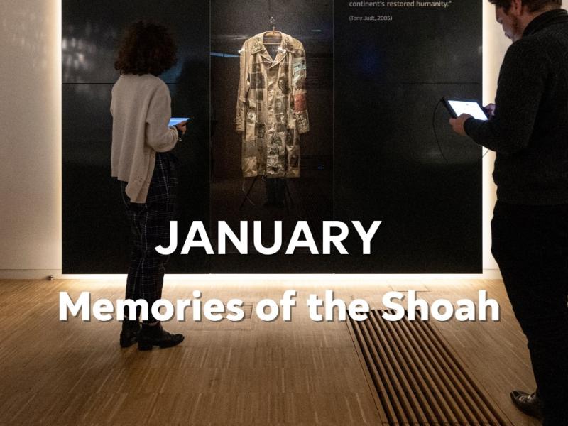 Two museum visitors looking at embroided coat