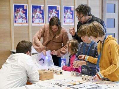 Adults and children collecting items for trail
