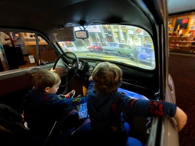 Two children inside car with projection