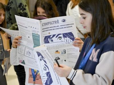 Young girl reading museum newspaper