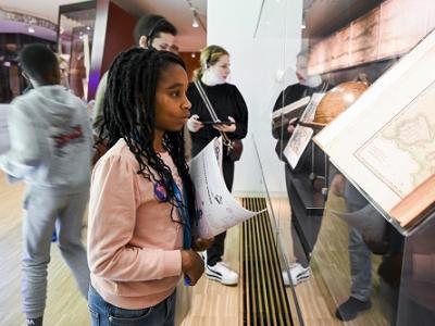 Girl with map in museum