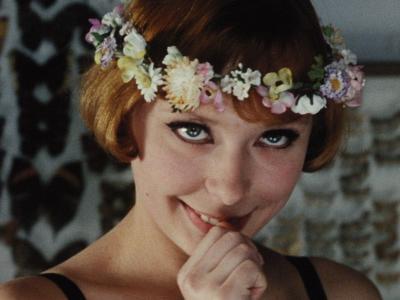 Woman with daisy chain smiling