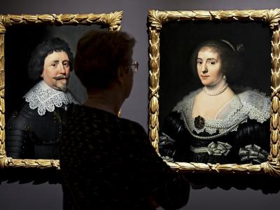 Paintings in exhibition with visitor