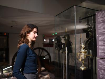 Woman looking at chalice from thirty years war