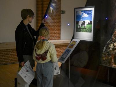 Parent and child looking at painting