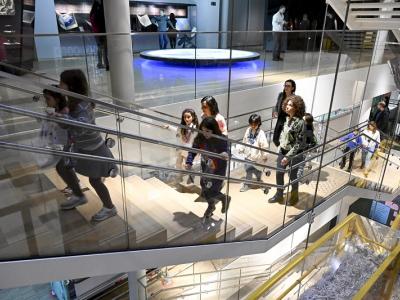 Family with kids walking up stairs in museum
