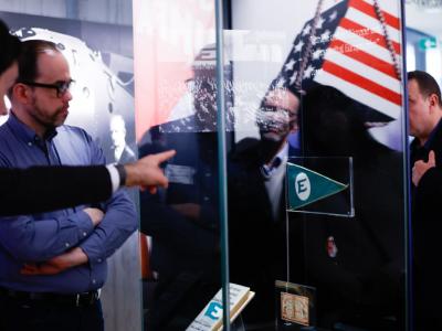 Men on museum tour looking at US flag