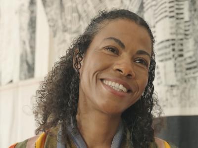 Headshot of woman in multicoloured top