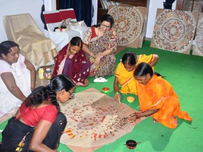 Indian women painting on floor