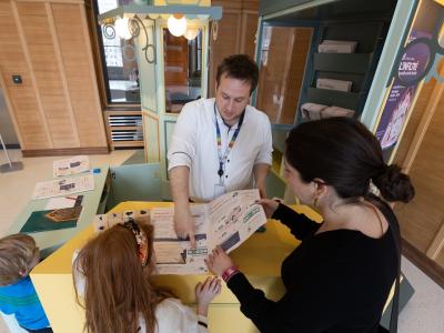 Family at desk in museum