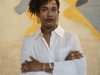 Woman in front of wall wearing white