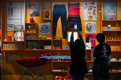 Visitors taking photo of museum showcase
