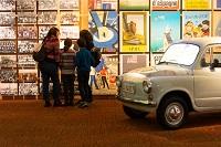 Family in museum in front of posters