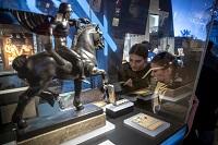 Two women looking at statue of horse