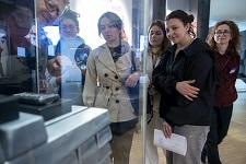 Visitors in museum looking at display case