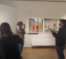 Students taking photos with mobiles in exhibition