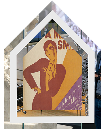 A woman with short hair in a dinner jacket, smoking a cigarette