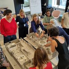 People gathered around model of exhibition