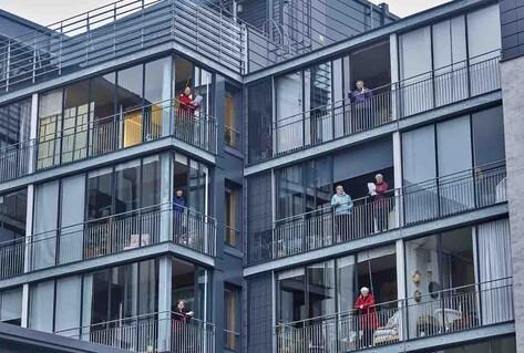 Elderly citizens on balconies singing